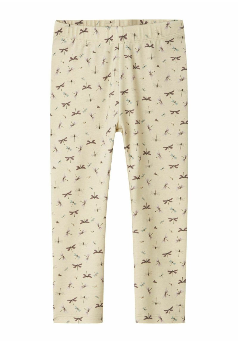 Jasno-beżowe legginsy z elastycznym paskiem w talii, z powtarzającym się wzorem ważki w brązie, niebieskim i fioletowym. Miękki materiał bawełniany.