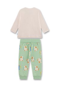 Baumwoll-Pyjama-Set mit einer cremefarbenen Langarmbluse und mintgrünen Hosen mit Cartoon-Affenmotiven und elastischen Bündchen.