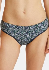 Bas de bikini floral avec une base marine ornée de petites fleurs blanches et bleues, avec une taille élastique et un tissu doux.