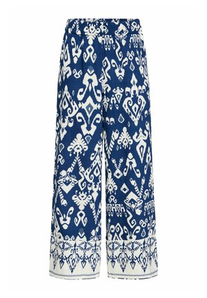 Pantofole a gamba larga blu e bianche con un motivo geometrico e una vita elasticizzata. Il tessuto sembra leggero con una superficie liscia.