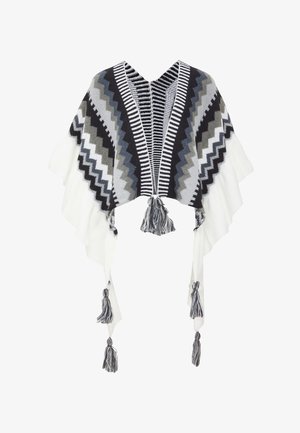 Gehaakte poncho in zwart, wit en grijs. Kenmerkt zich door zigzagpatronen, een V-hals ontwerp en franjes aan de zoom voor extra detail.