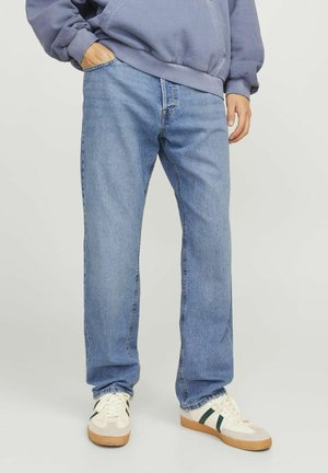 Light blue denim jeans with a straight leg design, featuring five pockets and a slight fade. Paired with cream sneakers and a gray hoodie.