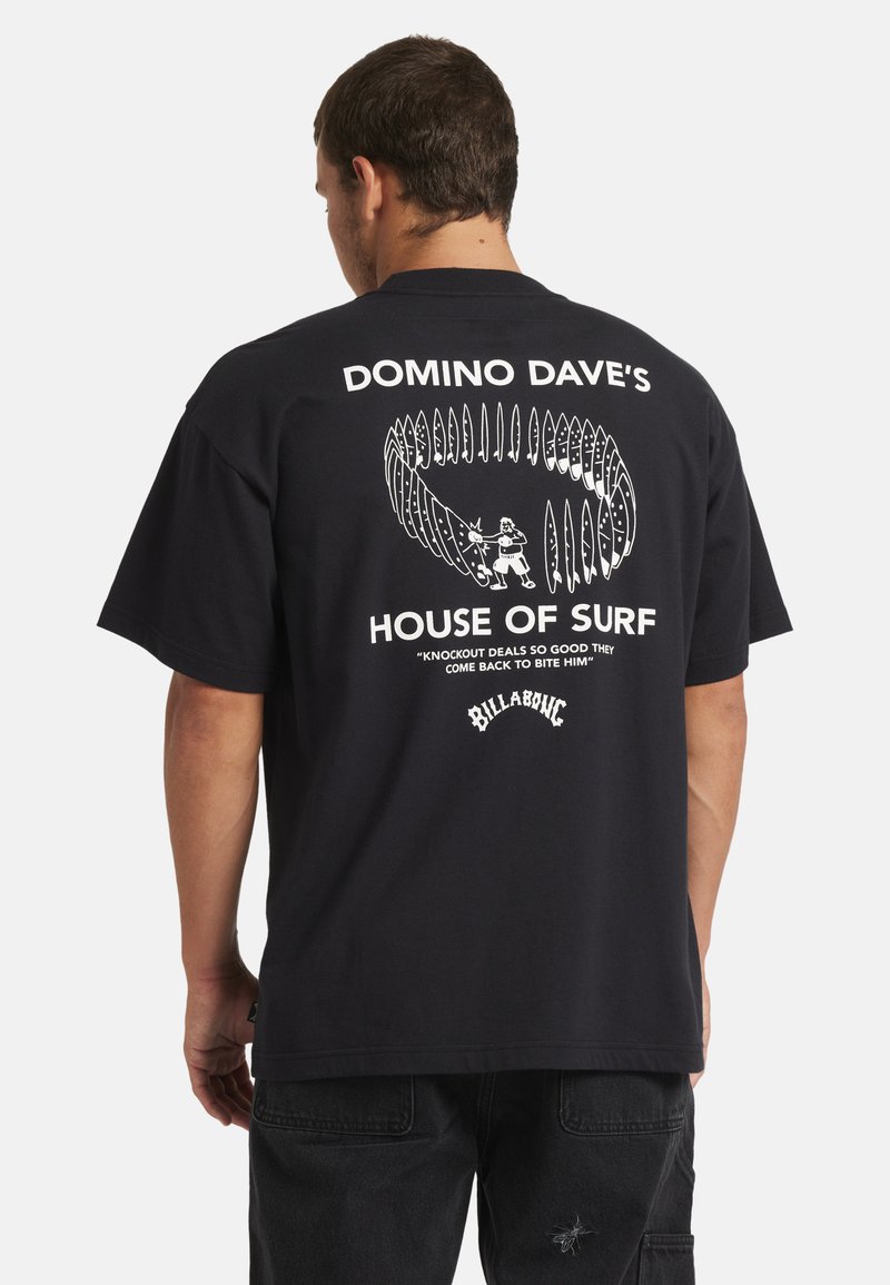Black cotton t-shirt featuring white graphic text "DOMINO DAVE'S HOUSE OF SURF" and surfboard design on the back. Relaxed fit, short sleeves.