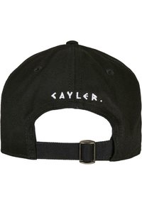 Black cap featuring white "CAYLER." embroidery on the back, made of sturdy fabric with a curved brim and adjustable strap closure.
