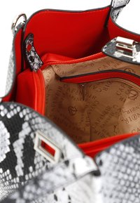 Borsa a tracolla con motivo in pelle di serpente bianco e nero, con un luminoso interno rosso, dotata di una tasca con zip e fodera impresso con logo. Accenti in hardware argentato.