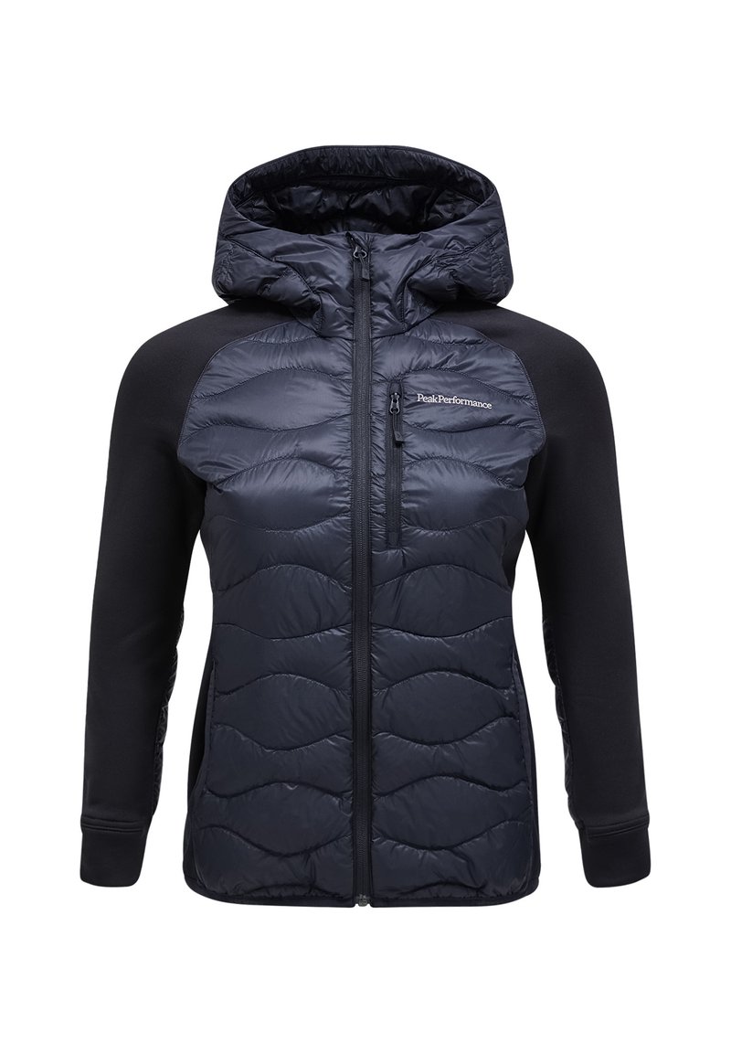 Marine blauwe pufferjack met capuchon; heeft een gequiltte textuur aan de voorkant en een gladde stof op de mouwen; vooraan sluiting met rits en logo-detail.