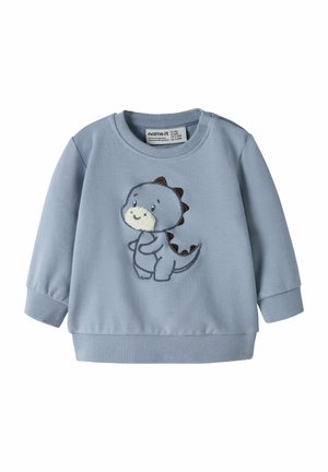 Pull bébé bleu clair à manches longues avec poignets et ourlet côtelés, avec un dinosaure dessin animé souriant aux piquants marron sur le devant.