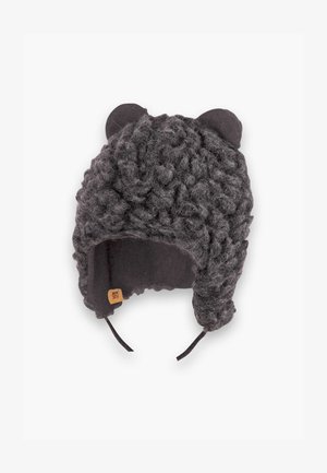 Γκρι πλεκτό καπέλο με υφή και φουντωτό εξωτερικό, διαθέτει αυτιά αρκούδας και ρυθμιζόμενο λουρί για το πηγούνι. Επενδυμένο εσωτερικό για ζέστη.