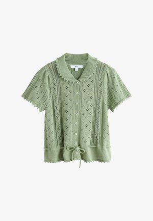 Light green short-sleeve knit cardigan with button front, scalloped edges, eyelet pattern, ribbed collar, and drawstring at hem.
