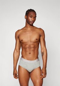 Gray cotton briefs with a light gray elastic waistband labeled "GAP." The fabric appears soft with a smooth texture.