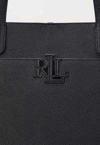 Black textured leather tote bag featuring an embossed "RL" logo on the front. Sturdy handles and a minimalist design.