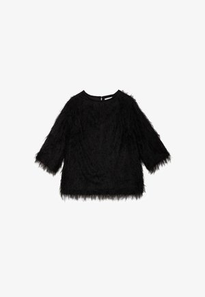 Crna plišana bluza s dugim rukavima, okruglim izrezom i teksturiranim, šagastim vanjskim dijelom. Ima diskretan zatvarač na leđima.