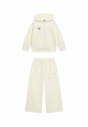 Giacca con cappuccio color crema con zip, patch di tulipano e pantaloni a gamba larga coordinati con vita elastica e tasche frontali.