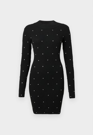 Juoda ratlankių trikotažo ilgos rankovės kūno formos suknelė su aukštu kaklu, dekoruota tolygiai išdėstytais smulkiais sidabriniais taškais.