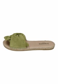 Green suede slide sandal with twisted bow detail, jute trim around the sole, and a flat footbed. Soft texture and casual design.