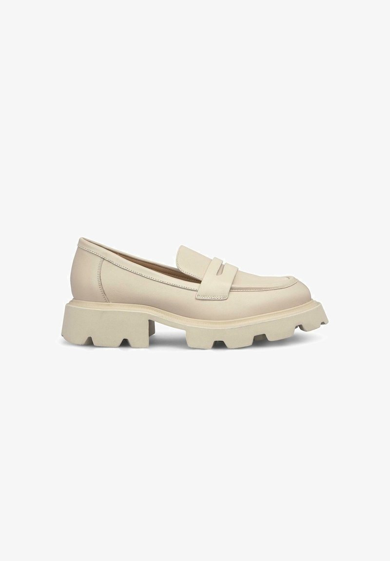 Beige leather loafer with a rounded toe and a thick, textured sole. Features a decorative strap across the vamp and stitching details.