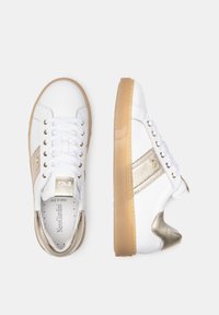 White low-top sneakers with a smooth leather upper, gold accents, and a textured rubber sole. Features traditional lacing and a padded collar.