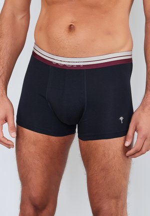 Boxer shorts in navy cotton with a striped elastic waistband in burgundy and grey. Features a small logo on the lower front.
