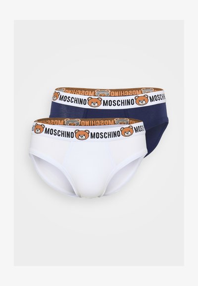 Divi vīriešu apakšveļa baltā un tumši zilā krāsā, ar rakstainu jostas daļu, kas rotāta ar lāča logo un "Moschino" tekstu. Mīksts kokvilnas materiāls.