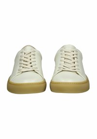 Weiße Leder-Sneaker im Low-Top-Design mit runden Zehen, flachen Schnürsenkeln und einer beigen Gummisohle mit strukturiertem Muster.