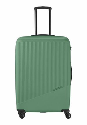 Hard-shell suitcase in mint green with vertical ribbed texture. Features a black telescopic handle and four black wheels for mobility.
