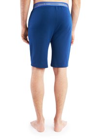 Blauwe katoenen shorts met een elastische tailleband, met een logo aan de bovenkant. De stof lijkt glad en lichtgewicht, met een slim-fit ontwerp.