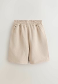 Pantaloni scurți bej cu talie elastică, confecționați dintr-un material moale, având deschideri largi la picior și fără buzunare sau închideri vizibile.