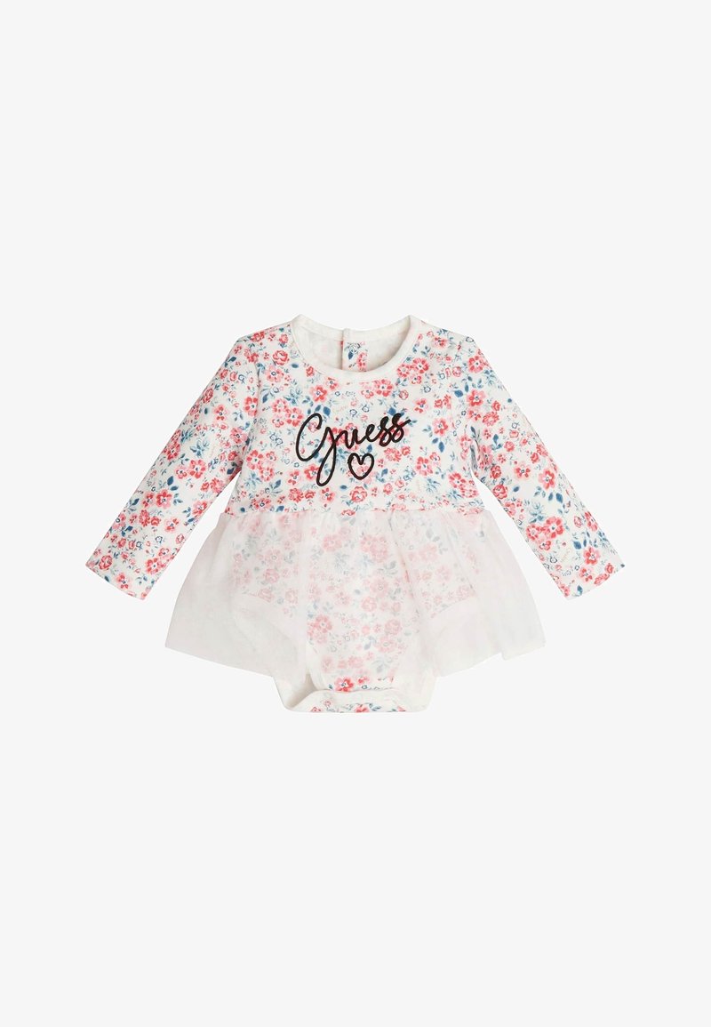 Body s dlouhým rukávem s květinovým potiskem, s tylovým překrytím a černým textem "Guess" na přední straně. Převážně bílý s červenými a modrými květinami.