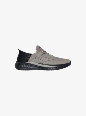 Hellgrau Sportschuh mit Wildlederoberfläche, schwarzer Mesh-Ferse, grauer Gummisohle, perforiertem Design und orangen Ösen.