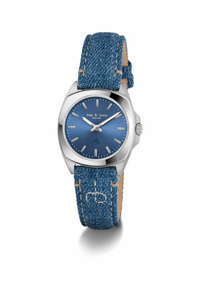 Silver-tone watch with a round case, blue dial, silver hour markers, and a denim textured strap. Features a smooth metallic finish.