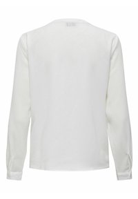 Blouse blanche à manches longues en tissu texturé, avec un col rond et des poignets boutonnés. Design simple avec une longueur droite.