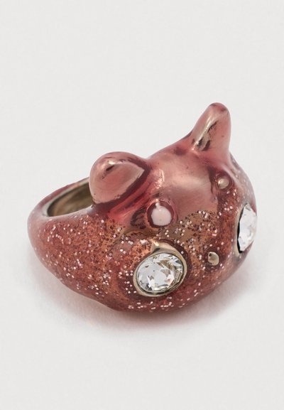 Prstan v roza zlatu z teksturirano, sijočo površino. Vsebuje dva prozorna kamna ter zaobljene oblike, ki spominjajo na ušesa in nos.