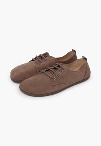 Brown suede lace-up shoes with a rounded toe, minimalistic design, and a flat rubber sole. Eyelets and stitching details are visible.