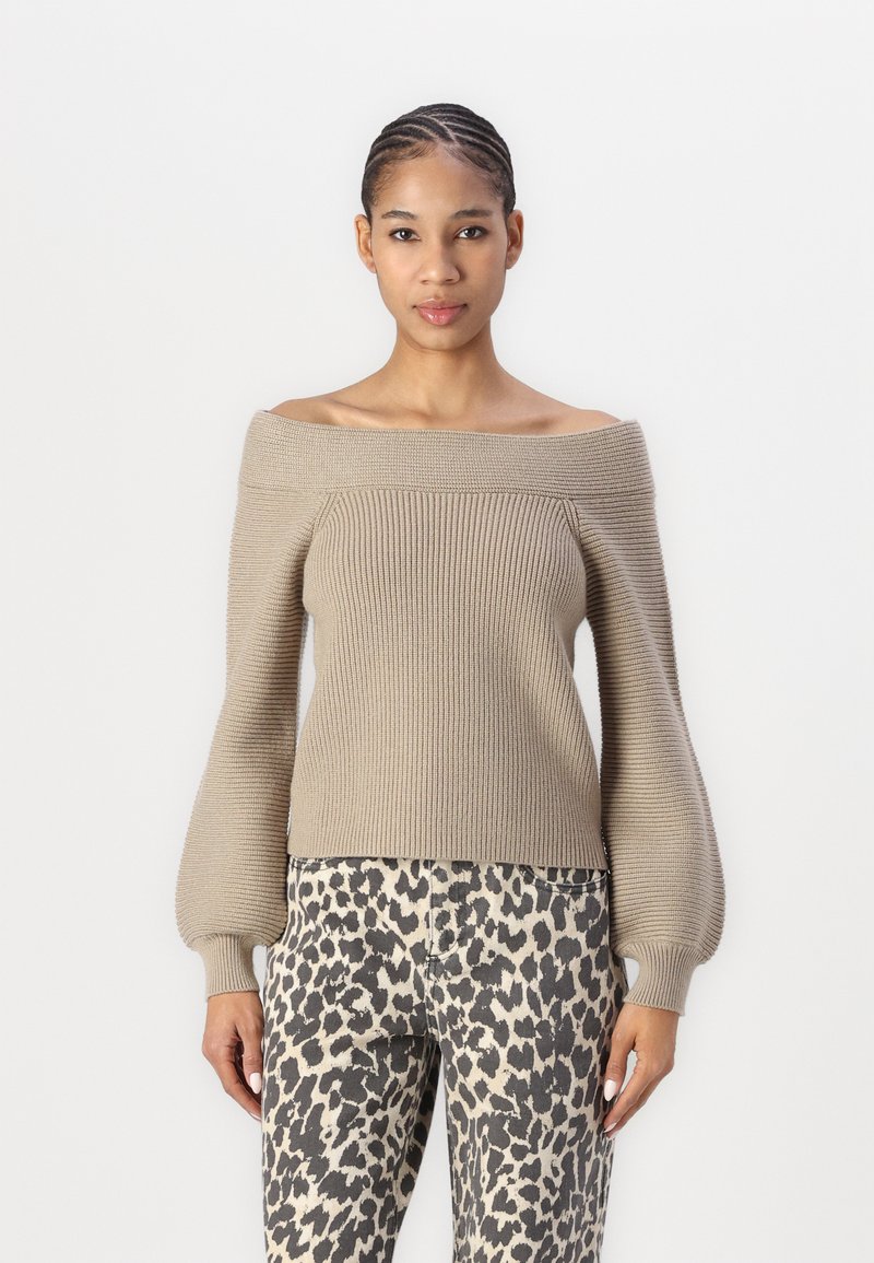 Khaki off-the-shoulder knit sweater with ribbed texture and balloon sleeves, paired with high-waisted animal print trousers, slim fit.