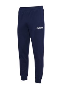Marineblå sweatpants lavet af blødt materiale med elastisk talje, manchetter ved anklerne og et hvidt "hummel" logo på venstre side.