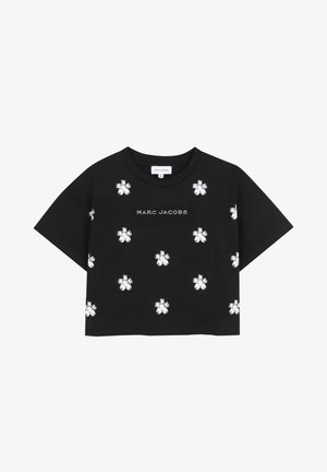 T-shirt noir court en coton, avec des motifs floraux blancs et le texte "MARC JACOBS" au centre. Manches courtes, coupe décontractée.