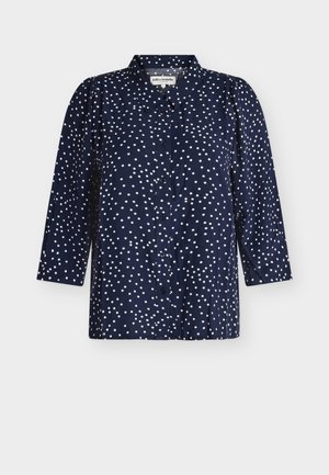 Blusa de manga larga azul marino con lunares blancos, cierre con botones en la parte delantera y cuello clásico.