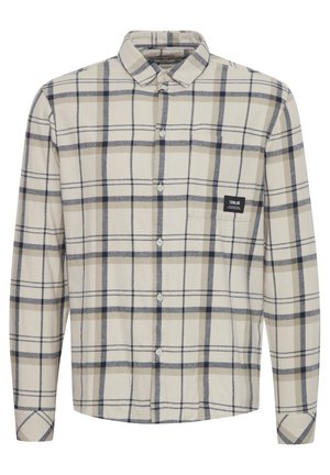 Långärmad rutiga skjorta i beige och marinblå, tillverkad av mjukt material. Har knappstängning framtill, krage och en logotyp på bröstet.