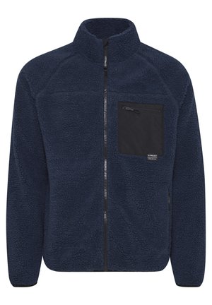 Navy blue fleece jacket with a high collar, zippered front, and a black chest pocket. Features textured fabric and elastic cuffs.