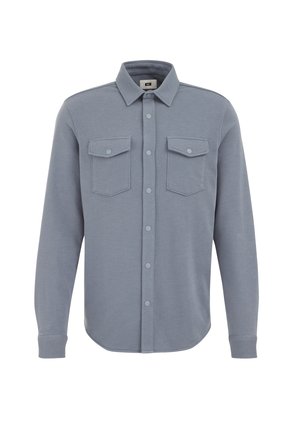Light gray button-up shirt with long sleeves, two chest pockets, and a rounded hem. Made of soft fabric with a smooth texture.