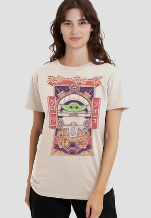 Beige T-shirt featuring a graphic print of a character in a vehicle. Design includes vibrant colors, intricate shapes, and Japanese text.