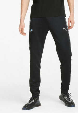 Black athletic pants with white side stripes, featuring a BMW logo on the left thigh; made of smooth fabric with a tapered fit.