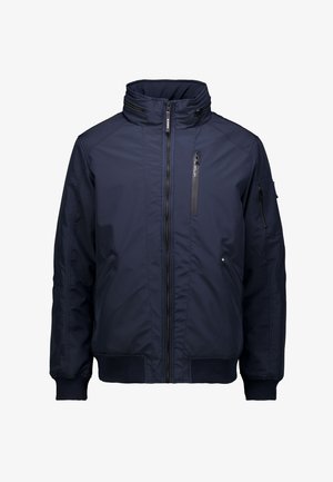 Marineblauwe geïsoleerde jas met hoge kraag, voorzijde met rits en meerdere ritszakken. Gemaakt van duurzame, gladde stof met ribgebreide manchetten.