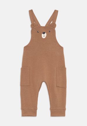 Braune Baumwoll-Overalls mit Bärenkopfdesign, Bärenohren an den Trägern und zwei vorderen Taschen; weicher Textil und schmal zulaufende Beinsäume.