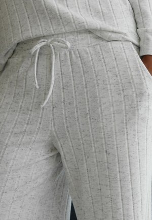 Light gray joggers made of soft, textured material, featuring vertical stripes and a drawstring waistband. Comfortable and casual design.