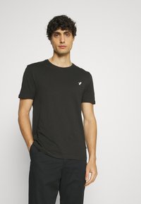 Black short-sleeve t-shirt made of soft cotton, featuring a round neckline and a small white logo on the left chest area.