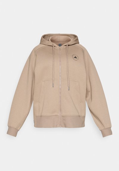 Felpa beige con zip, cappuccio con coulisse, tasche anteriori e polsini a costine. Presenta un logo circolare sull'area sinistra del petto.