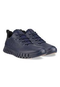 Sneakers in pelle blu navy con superficie testurizzata, punta arrotondata e suola in gomma flessibile caratterizzata da motivi intagliati per la traspirabilità.