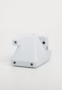 White instant camera with a triangular design, textured grip, colored top stripe, power button and shutter button on the side.