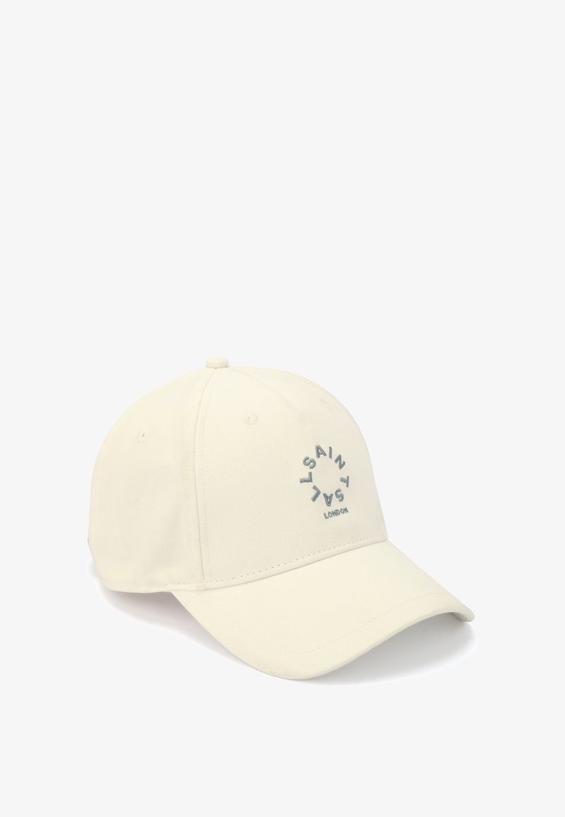 Beige baseball cap lavet af bomuld, med et cirkulært broderet logo i grå, en buet skygge og ventilationshuller på toppen.